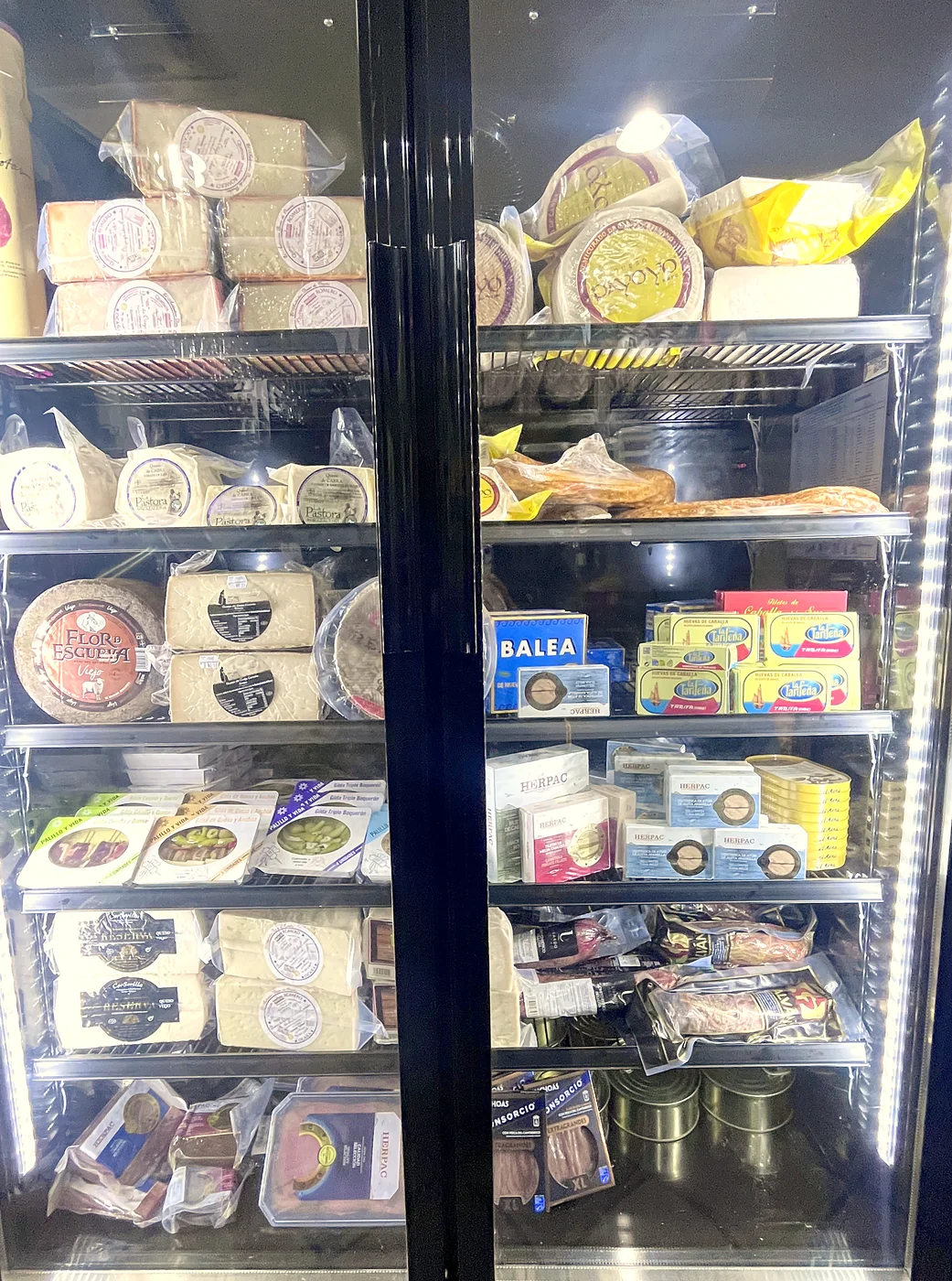 Vitrina con quesos curados, chacinas ibéricas y conservas del norte